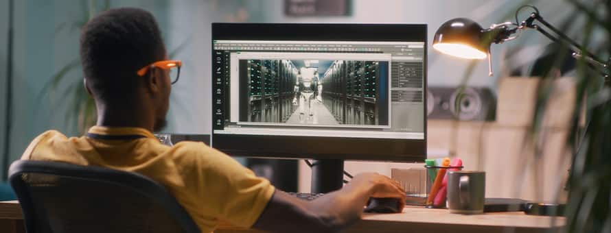 A student discovering what he can do with a 3D animation degree by using design software on a computer.