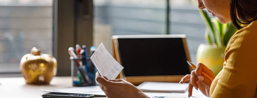 A woman reading tips about filing taxes as a student