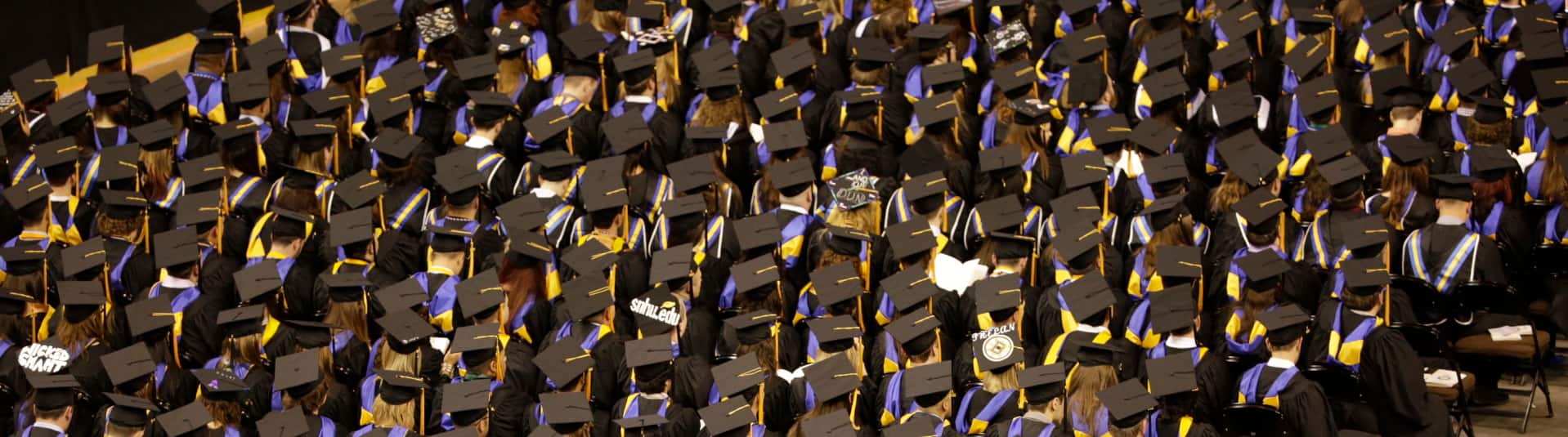Image of students with caps and gowns at commencement 