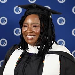 Adanze Chukwuocha '23G, SNHU master's in English and creative writing graduate, in a cap and gown