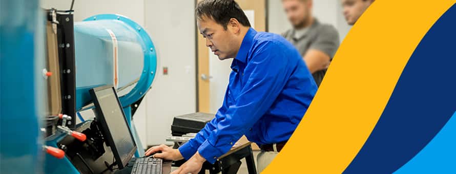 An aeronautical engineer working on a computer in a lab.