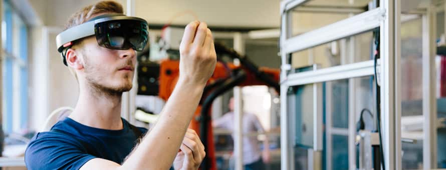 A man wearing high tech artificial intelligence googles working on an project