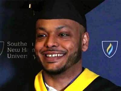 Andy Hernandez, who graduated from SNHU in 2023, wearing his graduation cap and gown.