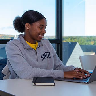 A student writing a short story for the 2020 Fall Fiction Contest