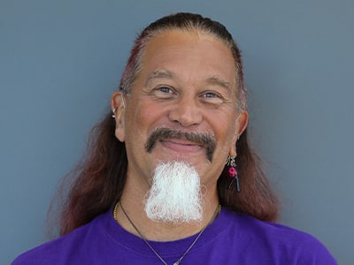 Arana Fireheart, Associate Dean, IT Foundations at SNHU, wearing a purple shirt