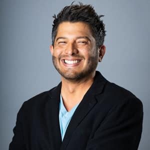 Dr. Enrique Barreiro, the senior associate dean of online business programs at SNHU, wearing a dark sports coat.