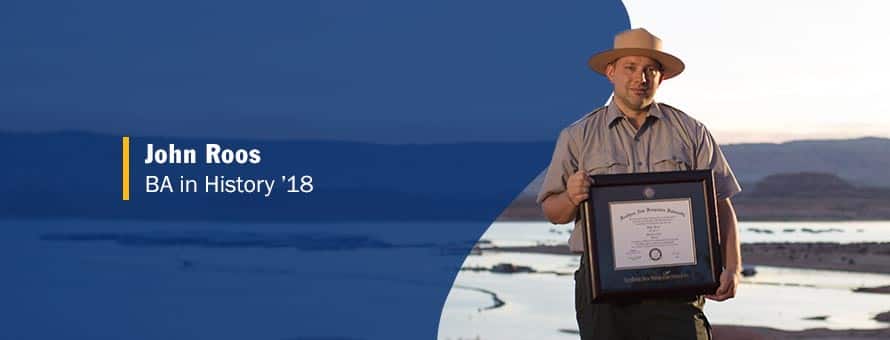 John Roos holding his framed SNHU degree and the text John Roos, BA in history '18.