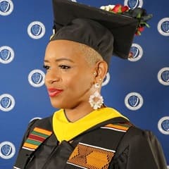 SNHU health information management graduate Bridget Tomlinson in her cap and gown.