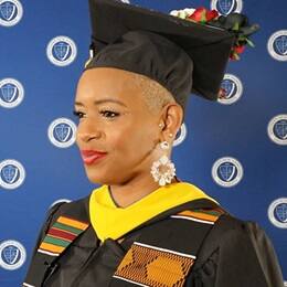 SNHU health information management graduate Bridget Tomlinson in her cap and gown. 