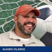 Alvaro Filardo, who earned his bachelor's in sports management from SNHU in 2021, wearing a polo shirt and orange baseball hat.