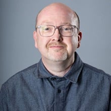 Dr. Nicholas Carte, graduate nursing faculty lead at SNHU, wearing a grey button down jacket.