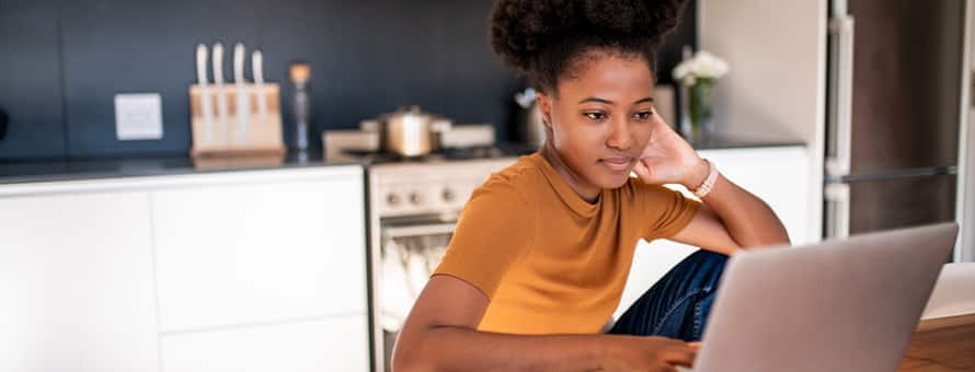 A person researching the difference between certificates and degrees on the laptop.