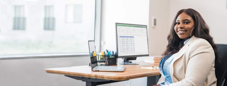An SNHU student sitting at a desk