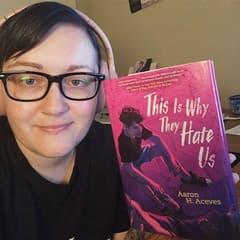 Chrishel Smith, an academic advisor at SNHU, holding a book