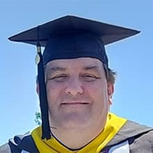 Christopher McGinnis in a graduation cap