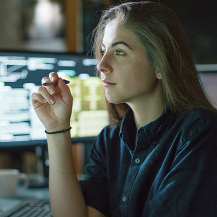 A cybersecurity analyst working on her laptop