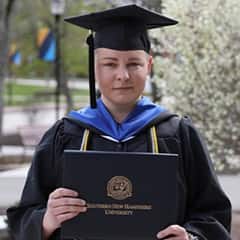Dani Chase, an admission counselor at SNHU with a sociology degree, wearing their graduation cap and gown.