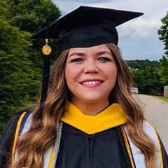 Danielle Upham, a bachelor's in social media marketing and a master's in digital marketing graduate from SNHU wearing her cap and gown.