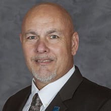 David Bynum, an adjunct instructor in SNHU's online criminal justice program, wearing a suit and tie.