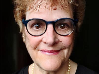 Deborah Gogliettino, the associate dean of online business programs at SNHU, wearing glasses and a pearl necklace.
