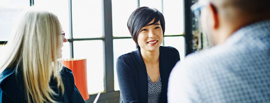 A woman smiles and explains that Delta Mu Delta is worth it