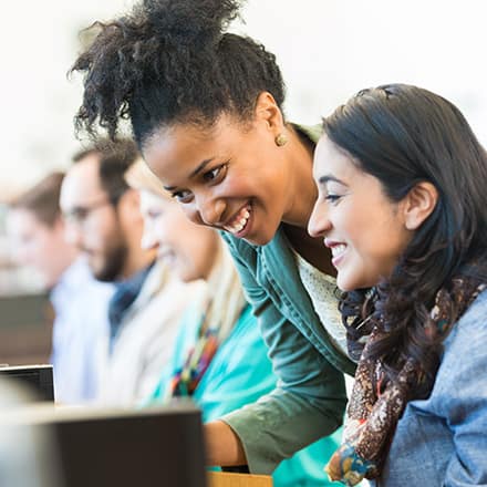 A college student and her advisor exploring BA vs BS degree programs on a desktop computer.