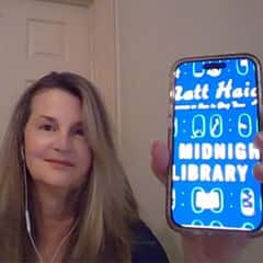 Dr. Cheryl Frederick, an executive director of STEM at SNHU, holding "The Midnight Library" by Matt Haig.