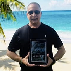 Dr. Hector R. Garcia, an associate dean of social sciences at SNHU, holding "The Wager: A Tale of Shipwreck, Mutiny and Murder" by David Grann.