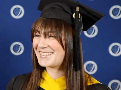 Emily Bevens, who earned her master's in forensic psychology from SNHU in 2023, wearing her cap and gown.