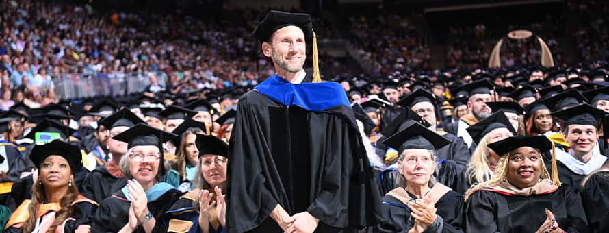 Dr. Jackson T. Zimmerman, a 2025 Distinguished Online Teaching Award recipient being recognized at SNHU's 2025 Spring Commencement.