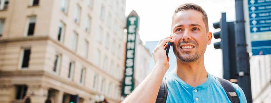 A person outside in a city talking on a cell phone