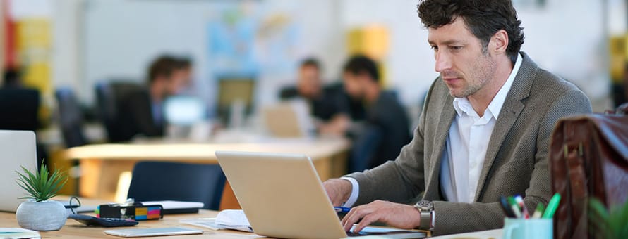 Man finding a new job ​on a laptop in a cafe 