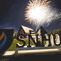 Fireworks above the Paul J. LeBlanc Hall and SNHU sign on campus