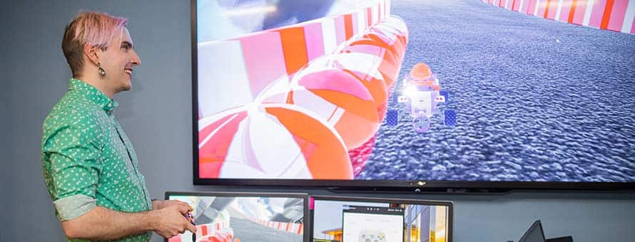 SNHU student holding a video game controller