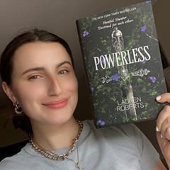 Alexa Gustavsen, content facilitator at SNHU, holding a book