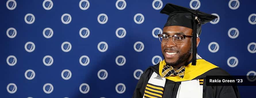 Rakia Green, in cap and gown, at SNHU's commencement ceremony after earning his master's in healthcare degree online.