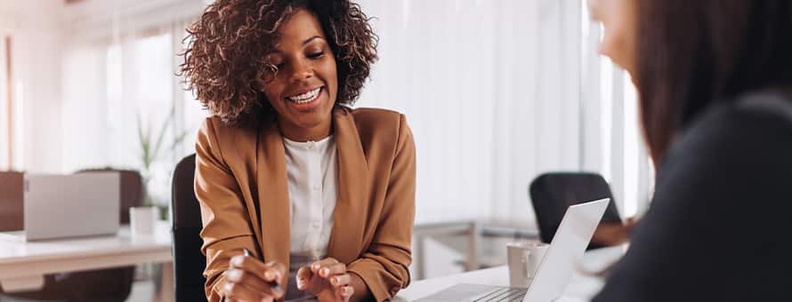 A woman who became a certified financial planner working with a client.