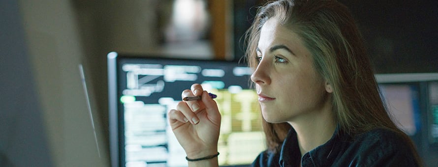 A cybersecurity analyst working on her laptop