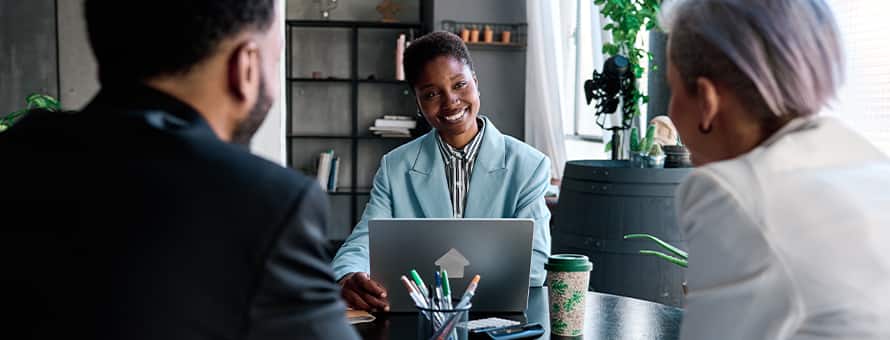 Three people having a conversation about how to become an investment banker