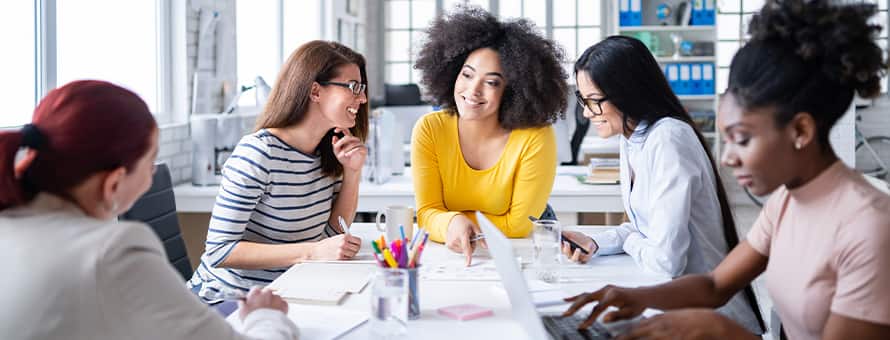 A group of professionals discussing how to become a social media manager