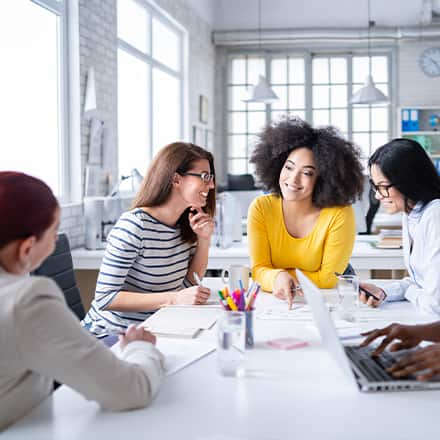 A group of professionals discussing how to become a social media manager