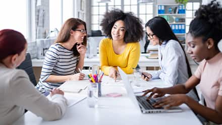 A group of professionals discussing how to become a social media manager