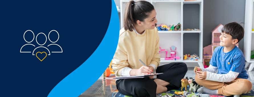 A blue graphic of three people and a yellow heart next to a psychologist talking to a child while sitting on the floor