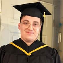 SNHU IT graduate Jacob Kane-Conrad wearing his cap and gown.