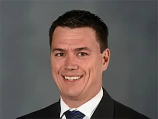 James Brooks, SNHU graduate who earned his MBA in 2022, wearing a suit and tie.