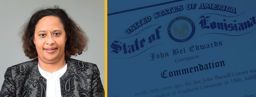 Joan Garner to the left of a letter of commendation from the State of Louisiana, honoring her father, John Burrell Garner.