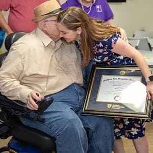 John Draper hugging his advisor Courtney Hannon