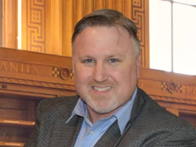 Joseph Timmons, Associate Dean, Data Analytics at SNHU, wearing a suit jacket and button down shirt.