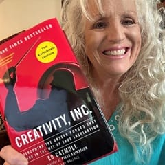 Dr. Karen Wilkinson, an associate dean of communication at SNHU, holding "Creativity, Inc" by Ed Catmull.