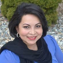 Katrina Jagroop-Gomes, who earned her MBA from SNHU in 2015, wearing a blue blouse and black scarf.